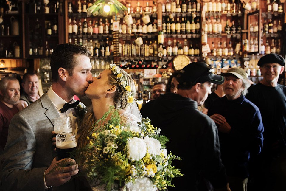 two people kissing in a pub