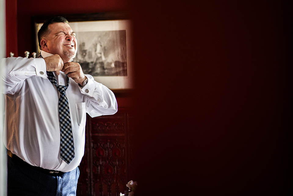 Groom putting on Tie