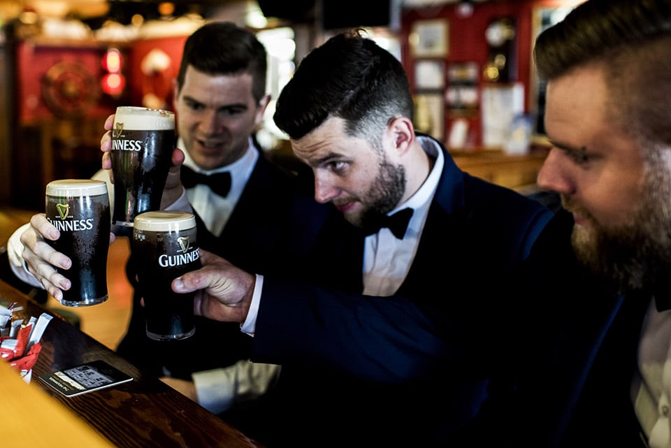 Groomsmen drinking pints