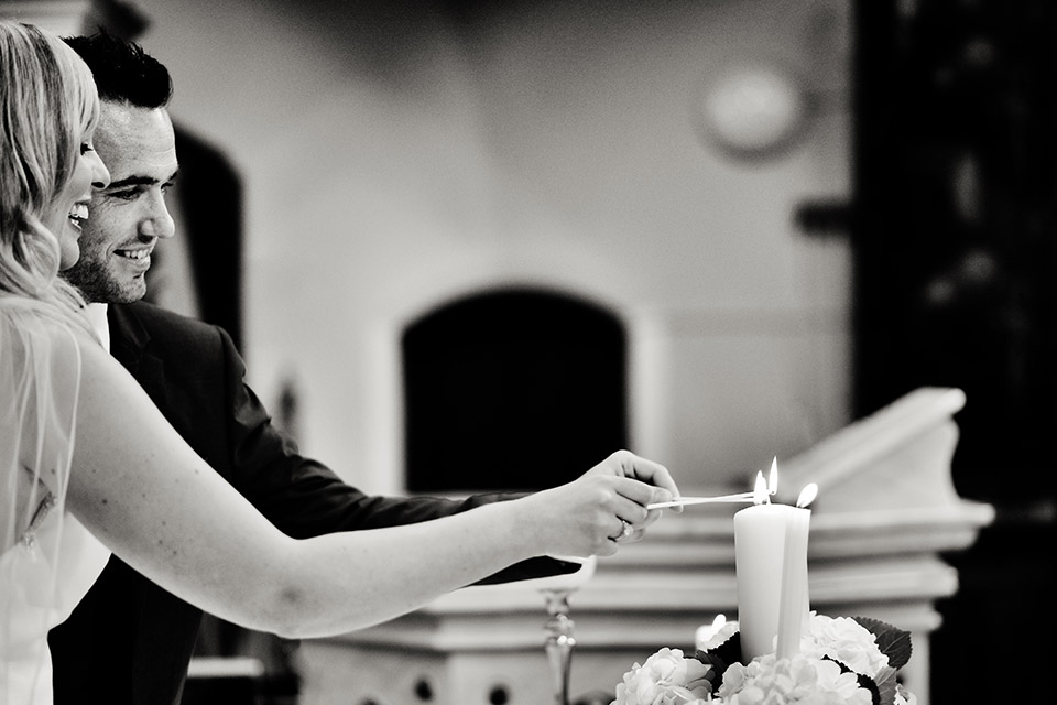 Two people lighting candles