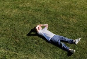 Kid lying on grass