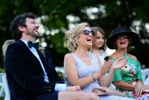 Laughing wedding guests